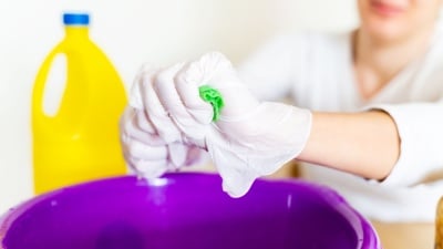 Person using gloves over bucket 