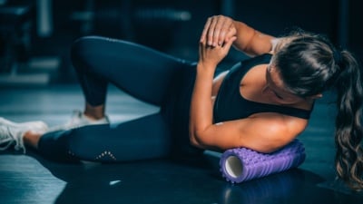 person using a purple foam roller