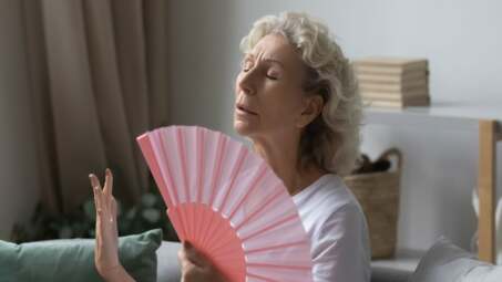 person cooling down with fan