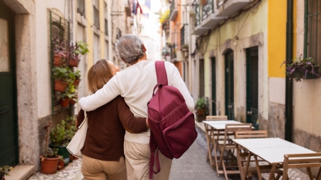 Senior couple walking down street in Lisbon