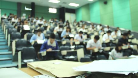 A college classroom filled with students, from the POV of the professor