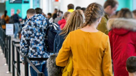 people standing in line in crowded airport