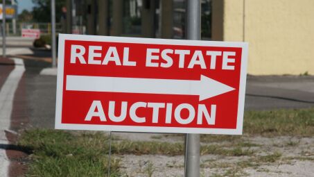 A sign for a real estate auction