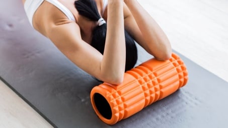 rolling elbows on a foam roller for a shoulder stretch