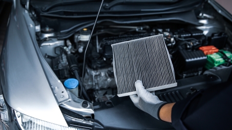 Auto mechanic doing something to car