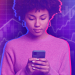 Woman looking at phone against stock market background