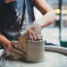 woman making pottery on a pottery wheel