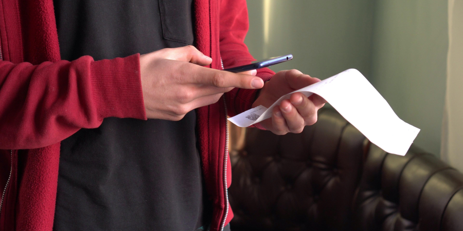 Person taking picture of receipt 