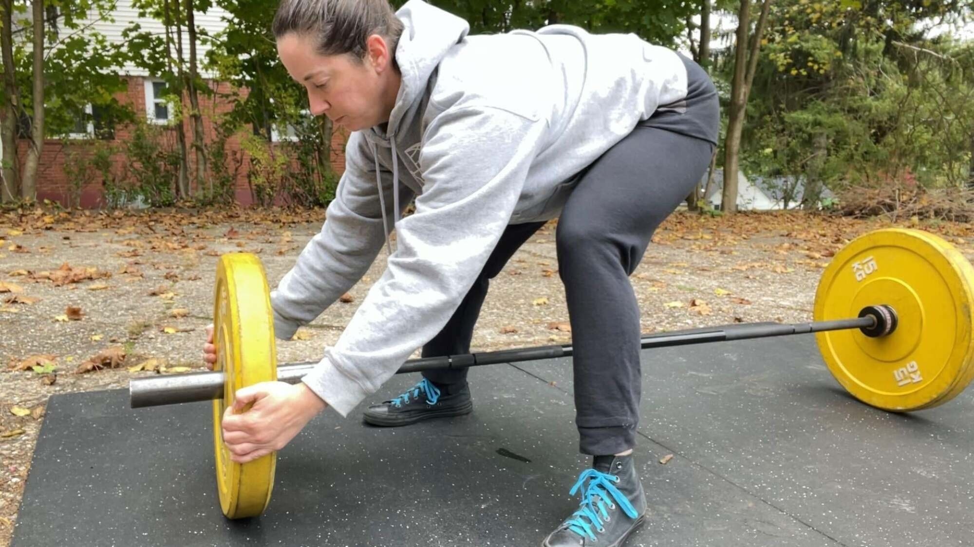 pulling plate onto the barbell