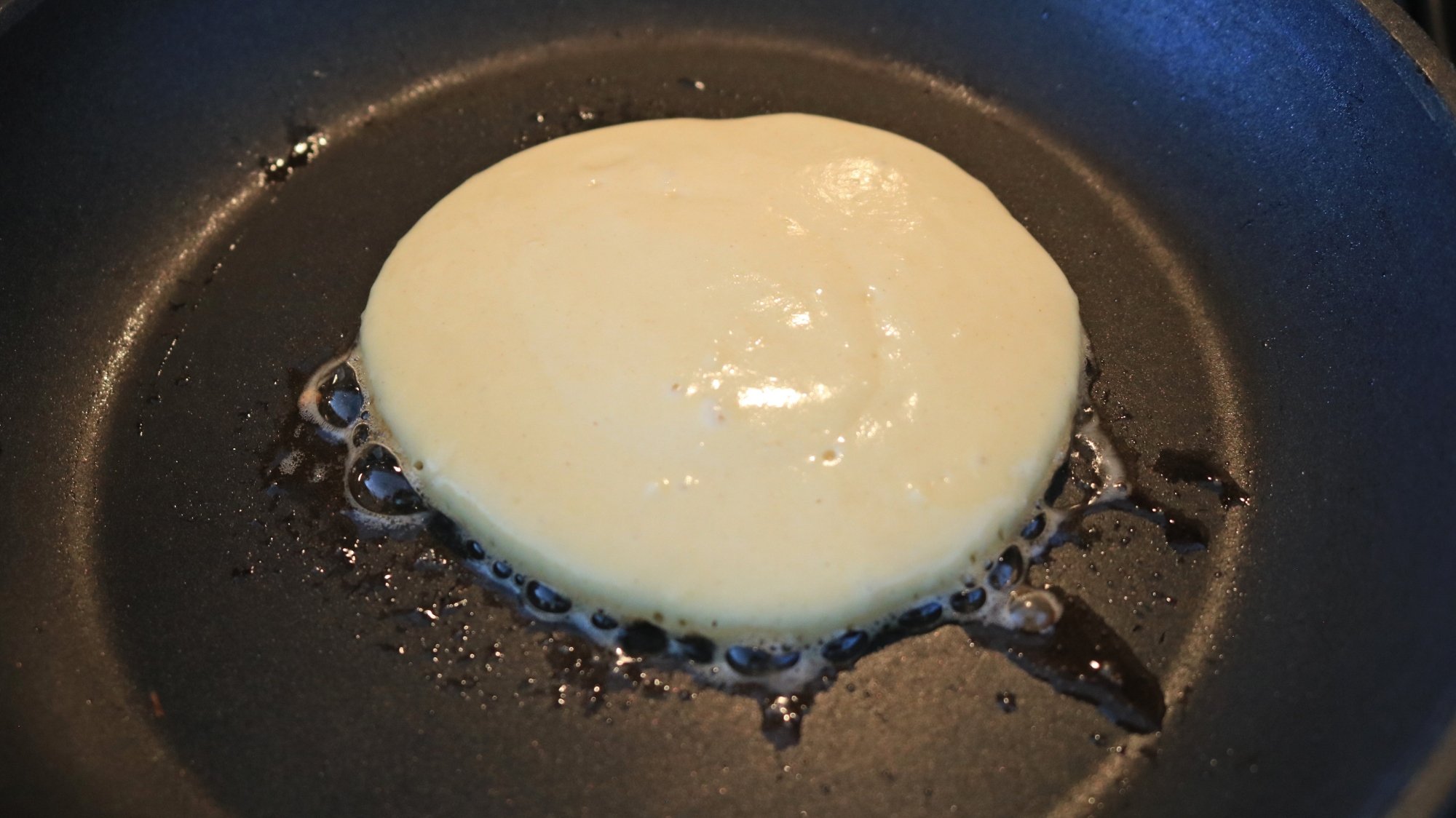 A smooth flat pancake in a pan.