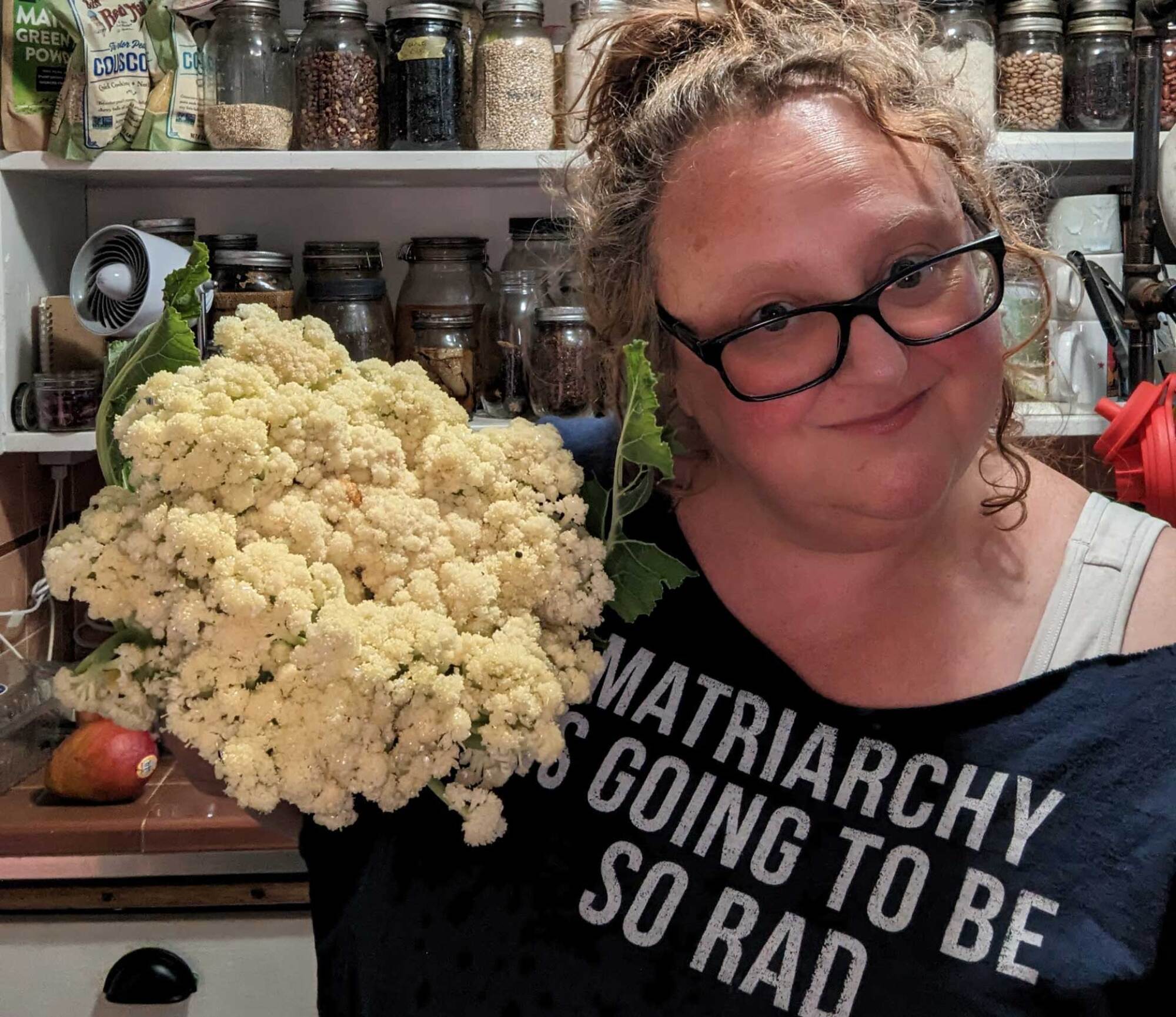 Author in kitchen w cauliflower from the garden